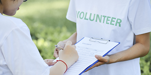 Joining non-profit organization Vounteer inviting people to join their non-profit organization and asking woman to write her contact information in form